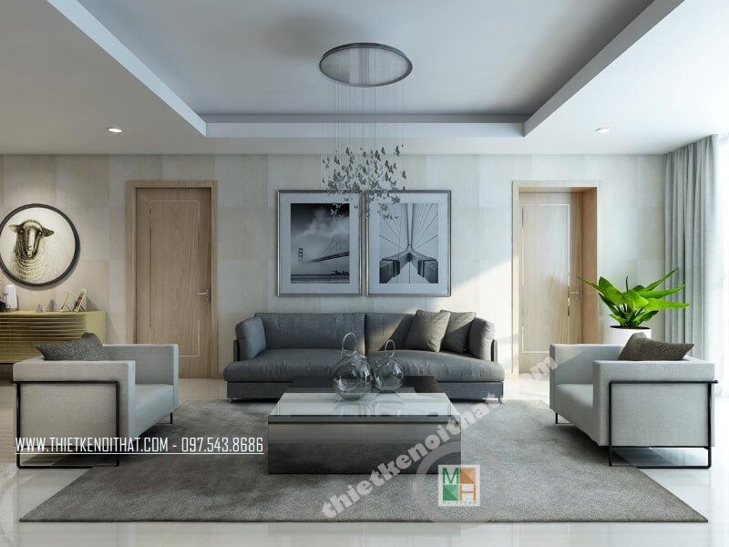 Bộ sofa bọc vải hiện đại với chiếc ghế sofa dài màu xám và hai ghế đơn màu xám tạo điểm nhấn nổi bật cho phòng khách chung cư